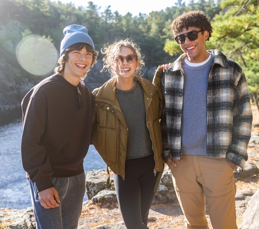 3 friends standing infront of mountain background